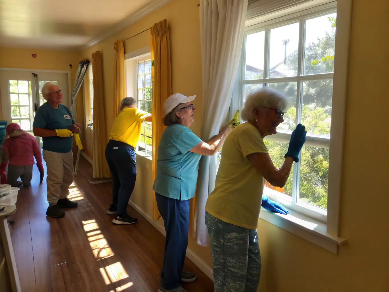 Volunteers assisting elderly residents with recreational activities in a community center, showcasing AHNAC's commitment to social support and community engagement.